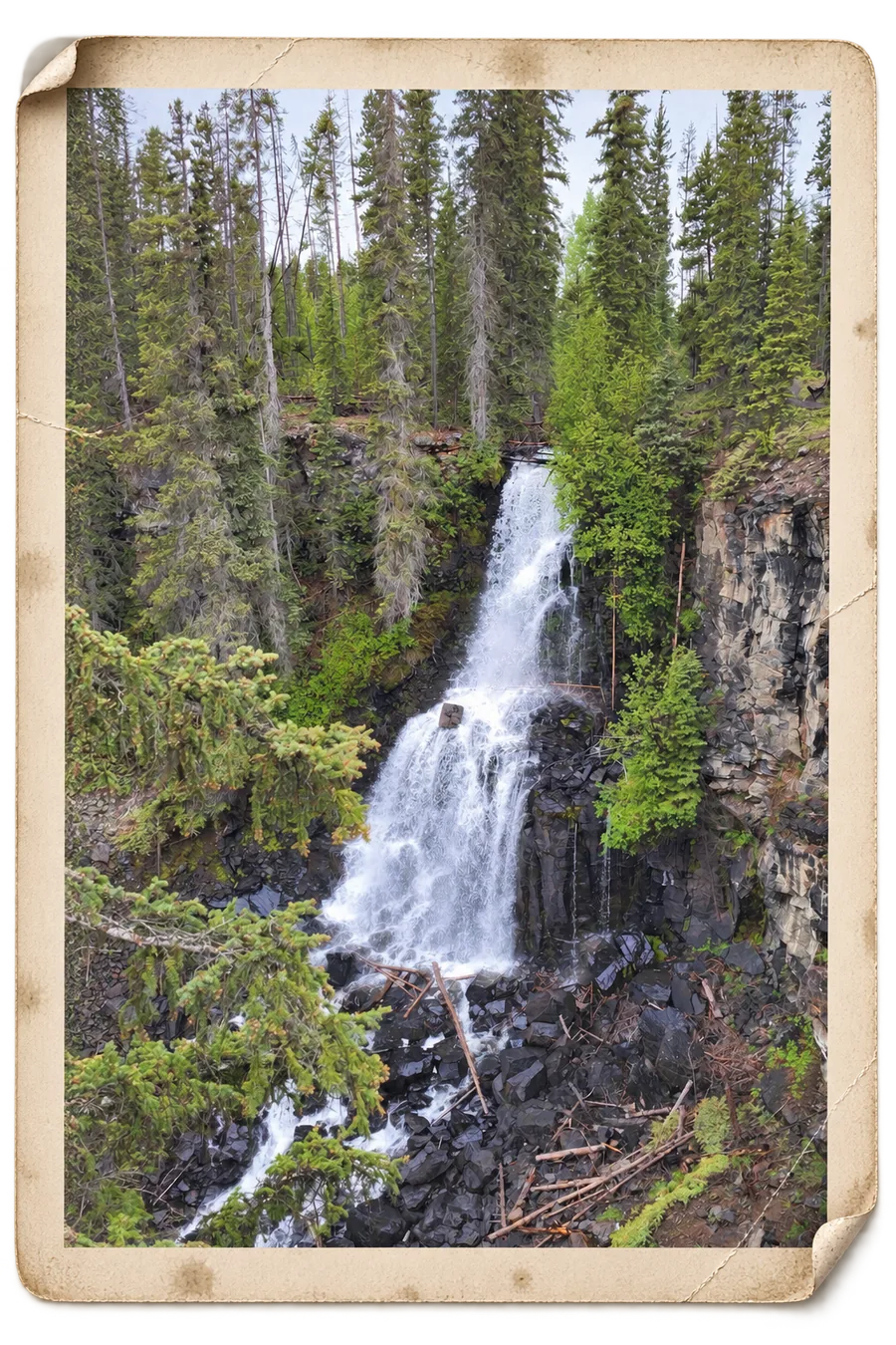 Hotnarko Falls dropping in two steps through a
               basalt canyon, as a weathered print.
